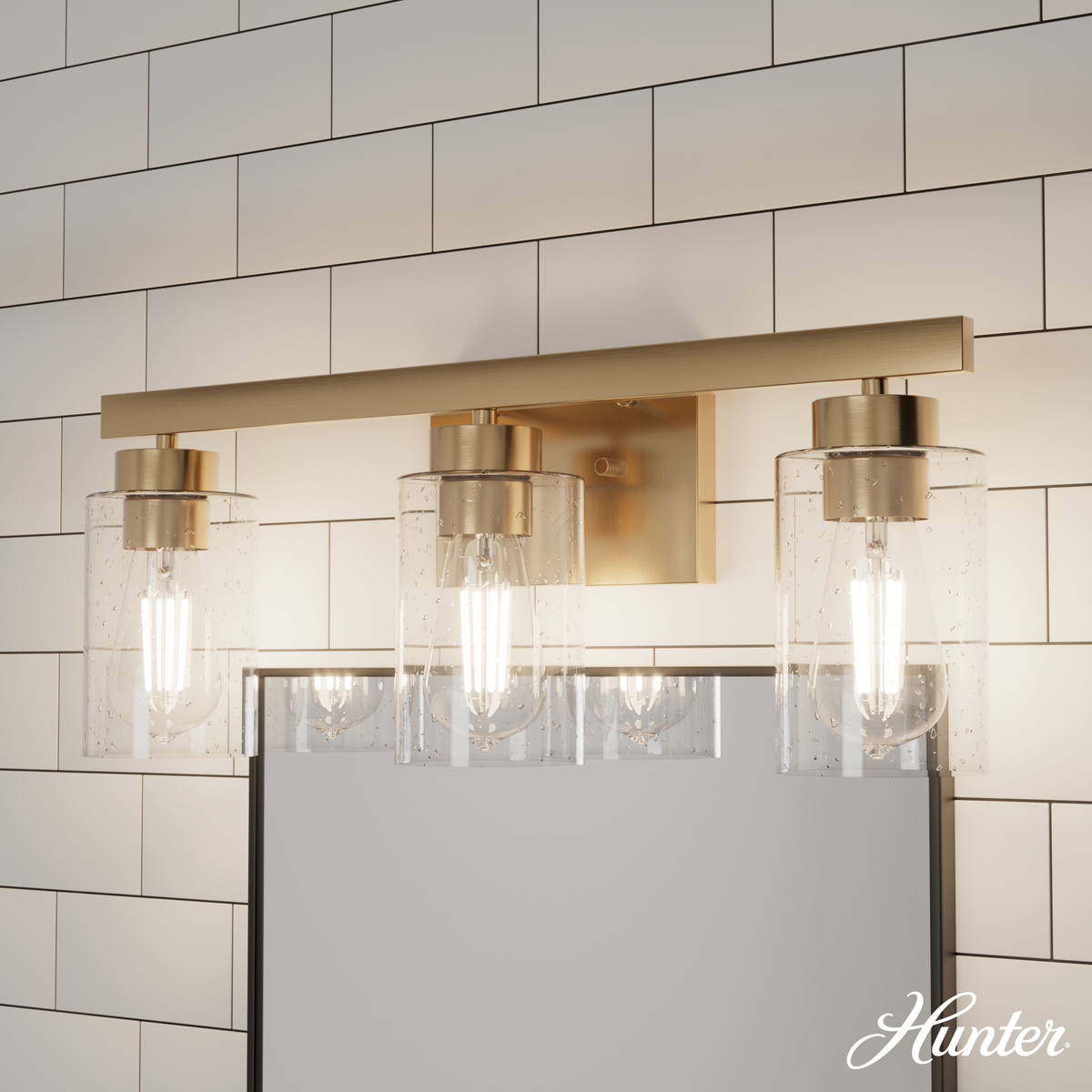 Hartland 22-inch 3-light Alturas Gold Vanity Light with Seeded Glass